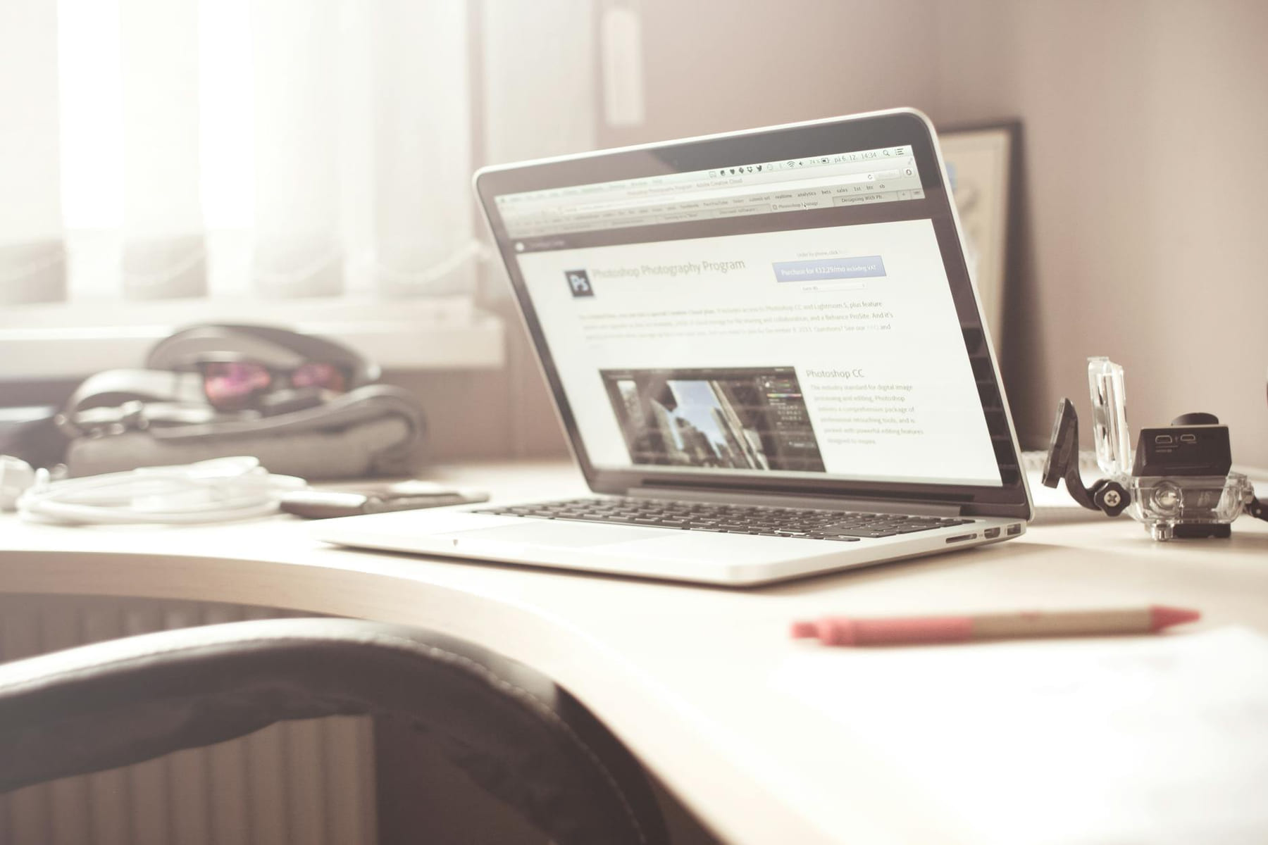 A clean and bright workspace featuring a laptop open on a wooden desk, highlighting a typical tech environment. on The Digital Hustler
