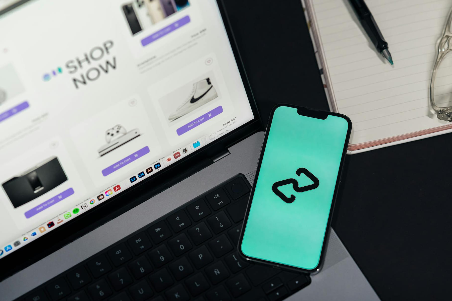 A smartphone and laptop displaying online shopping platforms, suggesting digital retail. on The Digital Hustler