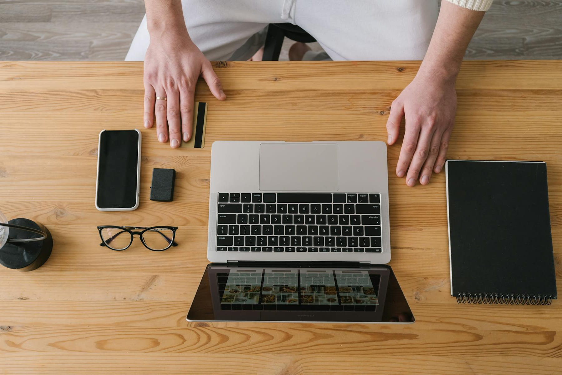 Hands on a laptop, surrounded by gadgets, on a wooden desk. Ideal for online shopping themes. on The Digital Hustler