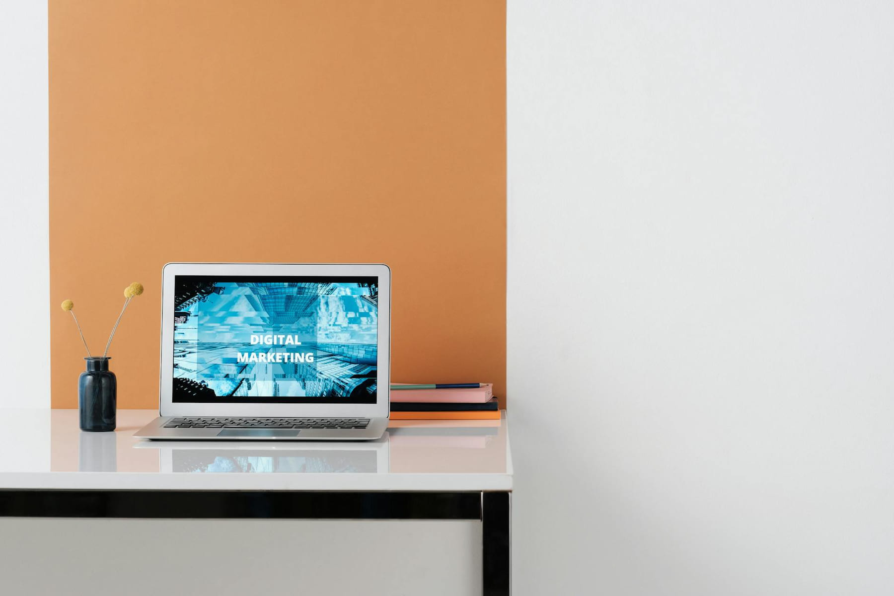 A clean, modern workspace featuring a laptop with digital marketing on screen, ideal for business use. on The Digital Hustler
