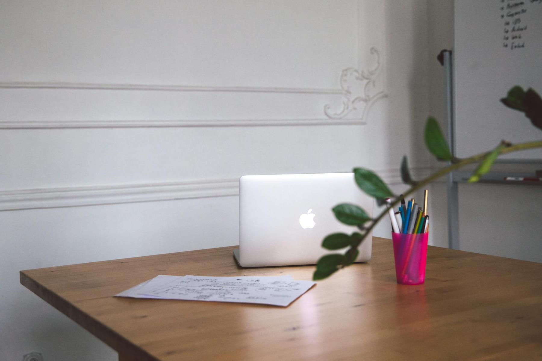 A clean desk with a laptop, notes, and pens creating a modern workspace. on The Digital Hustler