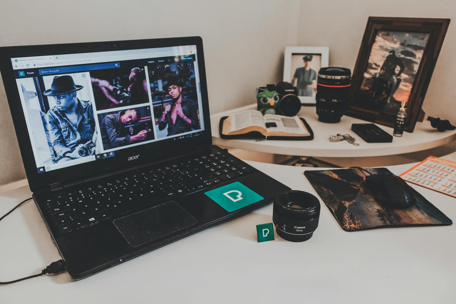 A modern workspace featuring a laptop, photography equipment, and an open book on a desk. on The Digital Hustler